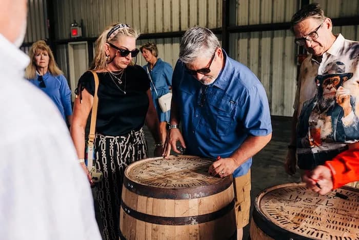 A group gathered around barrel heads at a barrel pick